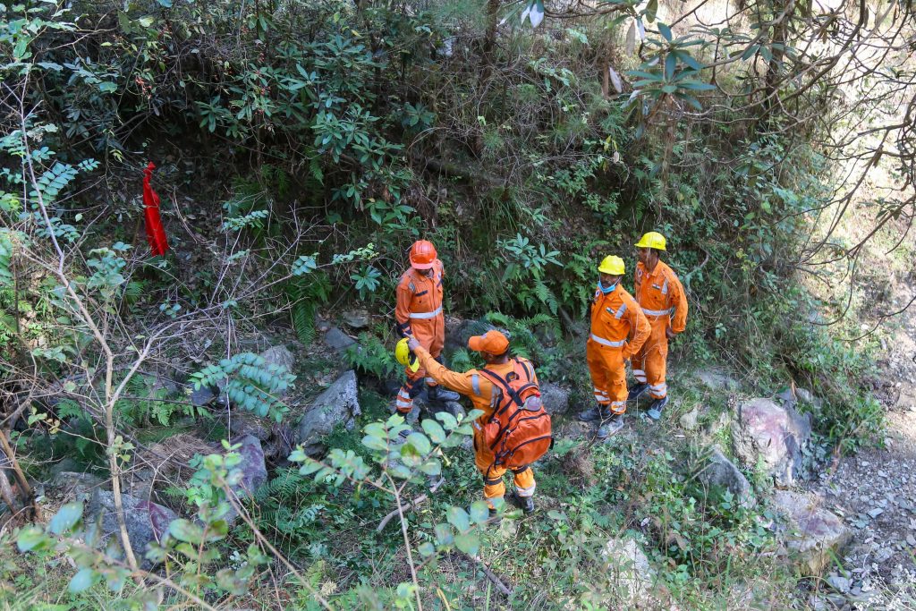 NDRF personnel on hill above tunnel | Suraj Singh Bisht | ThePrint